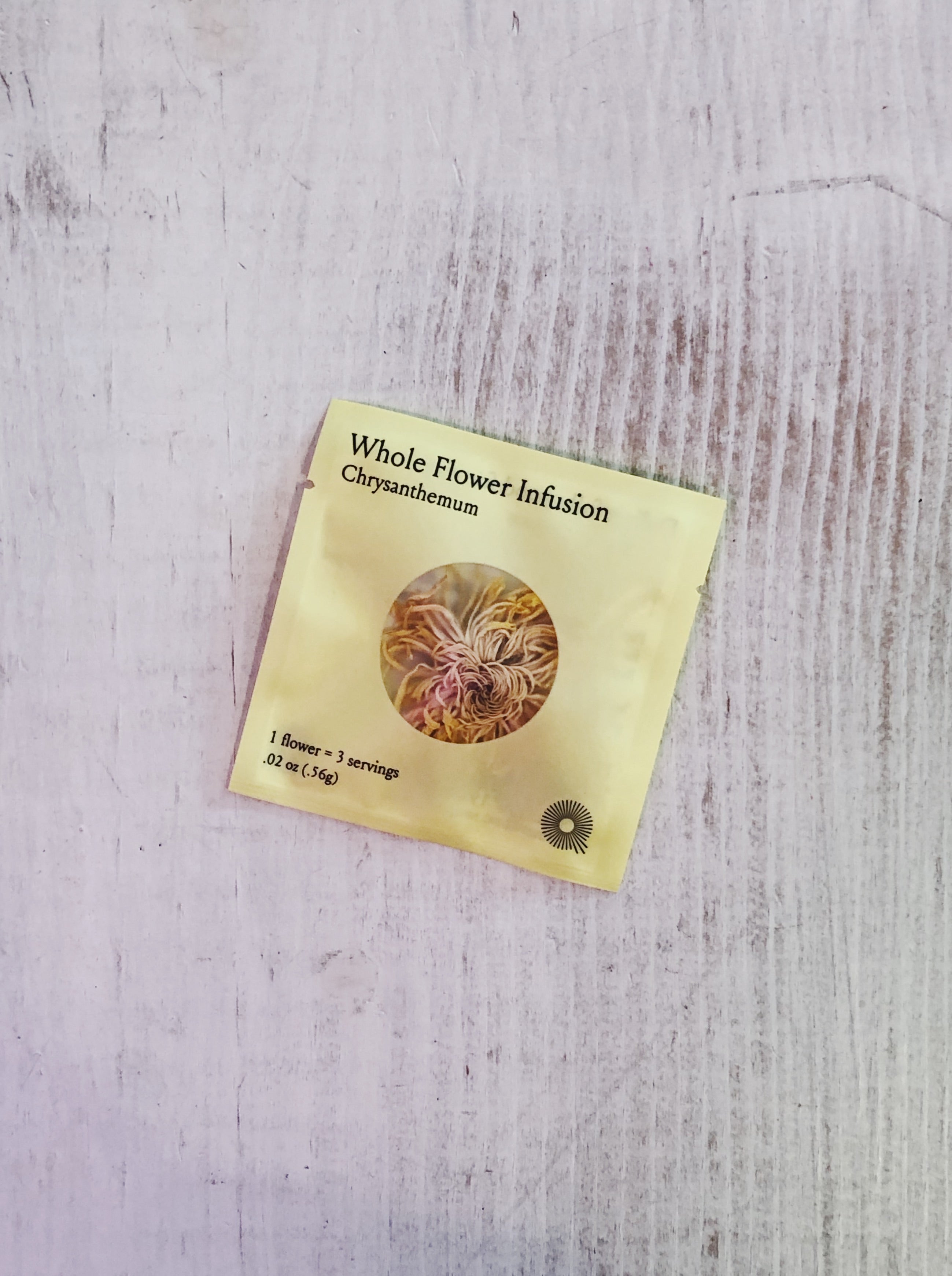 A packet containing a whole Royal Chrysanthemum flower, designed for brewing tea, with vibrant petals and a delicate, aromatic fragrance for a soothing, floral infusion.