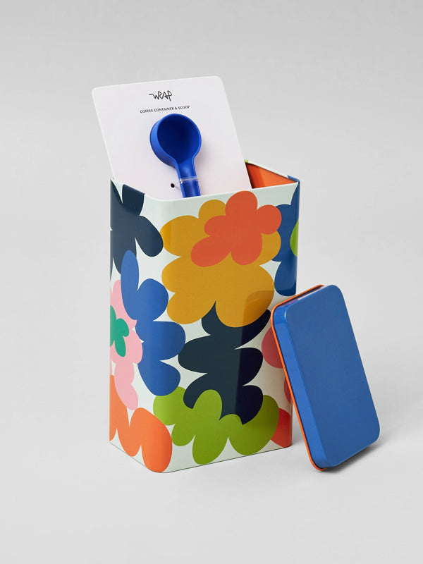 A decorative coffee tin featuring a vibrant abstract flower design, perfect for storing coffee or adding a colorful, artistic touch to your kitchen counter.