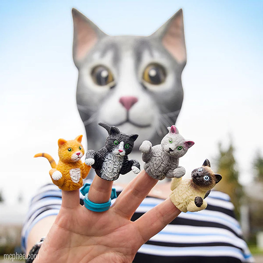 A cute cat finger puppet made from soft, flexible material. The puppet fits comfortably on the finger and features detailed features like ears, eyes, and whiskers, perfect for imaginative play or storytelling.