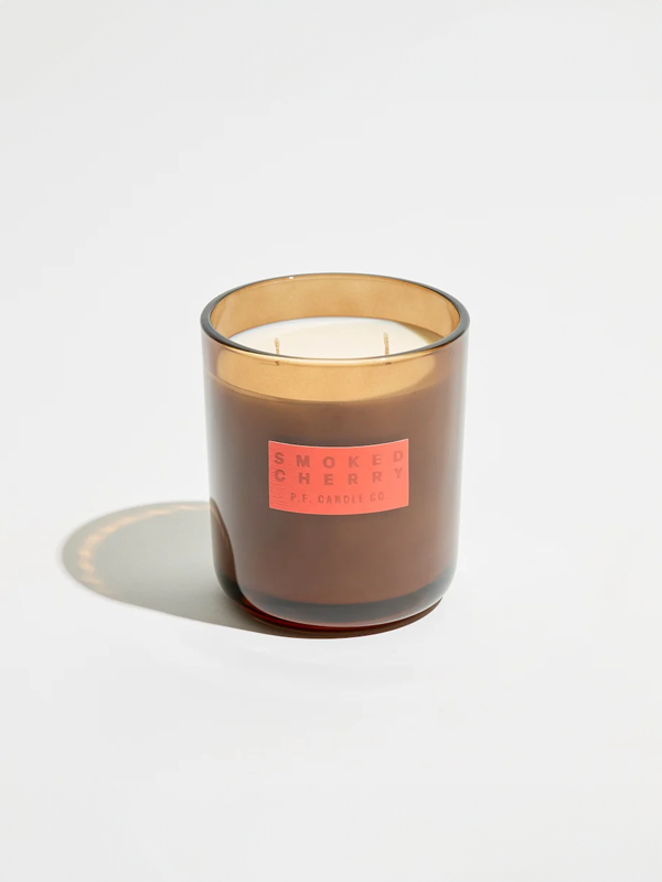 A HI-FI candle with a smoked cherry fragrance, offering a warm, rich scent that blends sweet cherry notes with a hint of smoky depth for a cozy, inviting atmosphere.