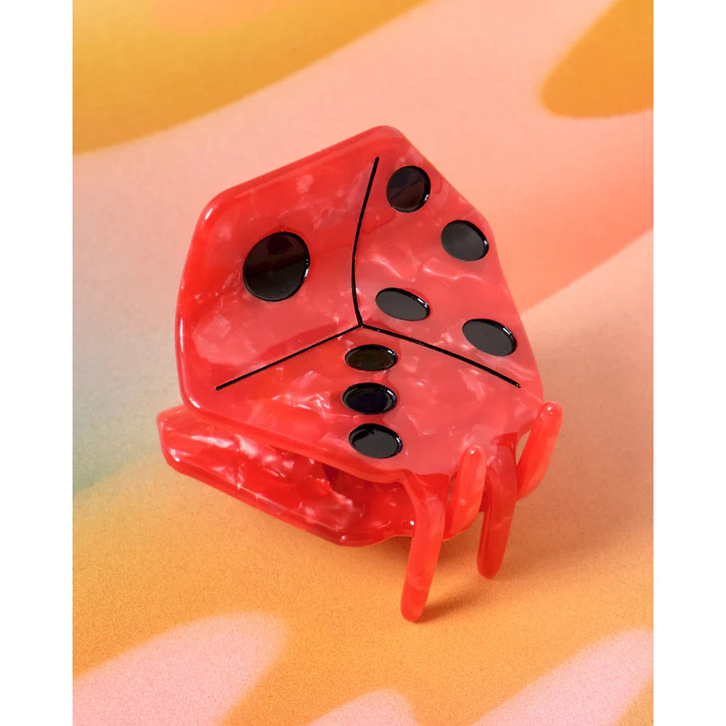 A bold red hair claw shaped like a dice, adding a playful and stylish touch to your hairstyle with its unique design and vibrant color.