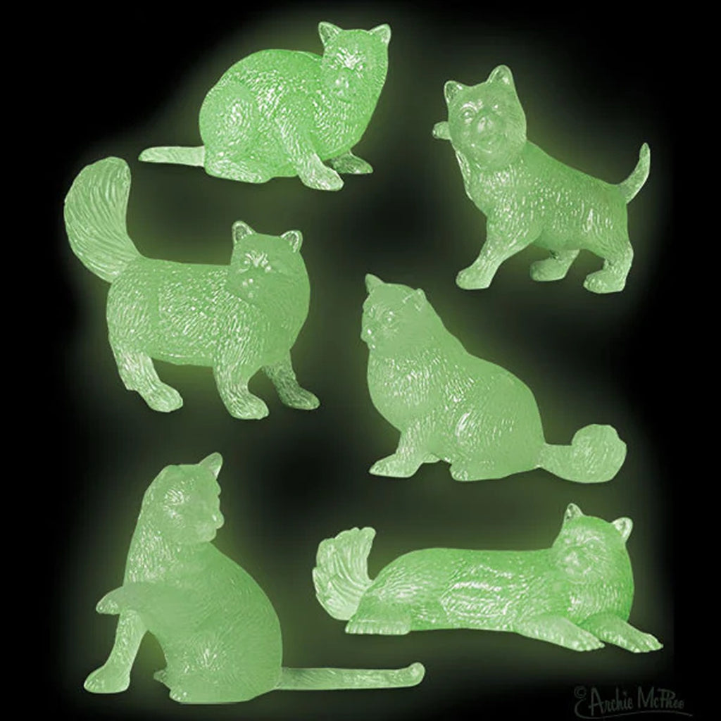 A set of small, glow-in-the-dark cat figures, each with unique poses and features.