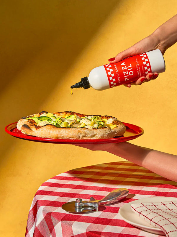 Pizza oil infused with herbs and spices, perfect for drizzling on pizza, pasta, or other dishes for an extra burst of savory flavor.