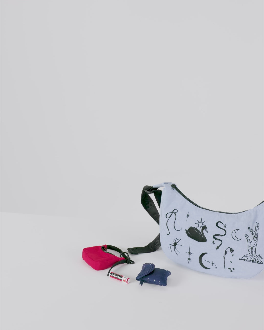 Crescent Bag Charm by Baggu, a playful and stylish accessory featuring a crescent-shaped design, perfect for adding a fun touch to your bag or keychain.