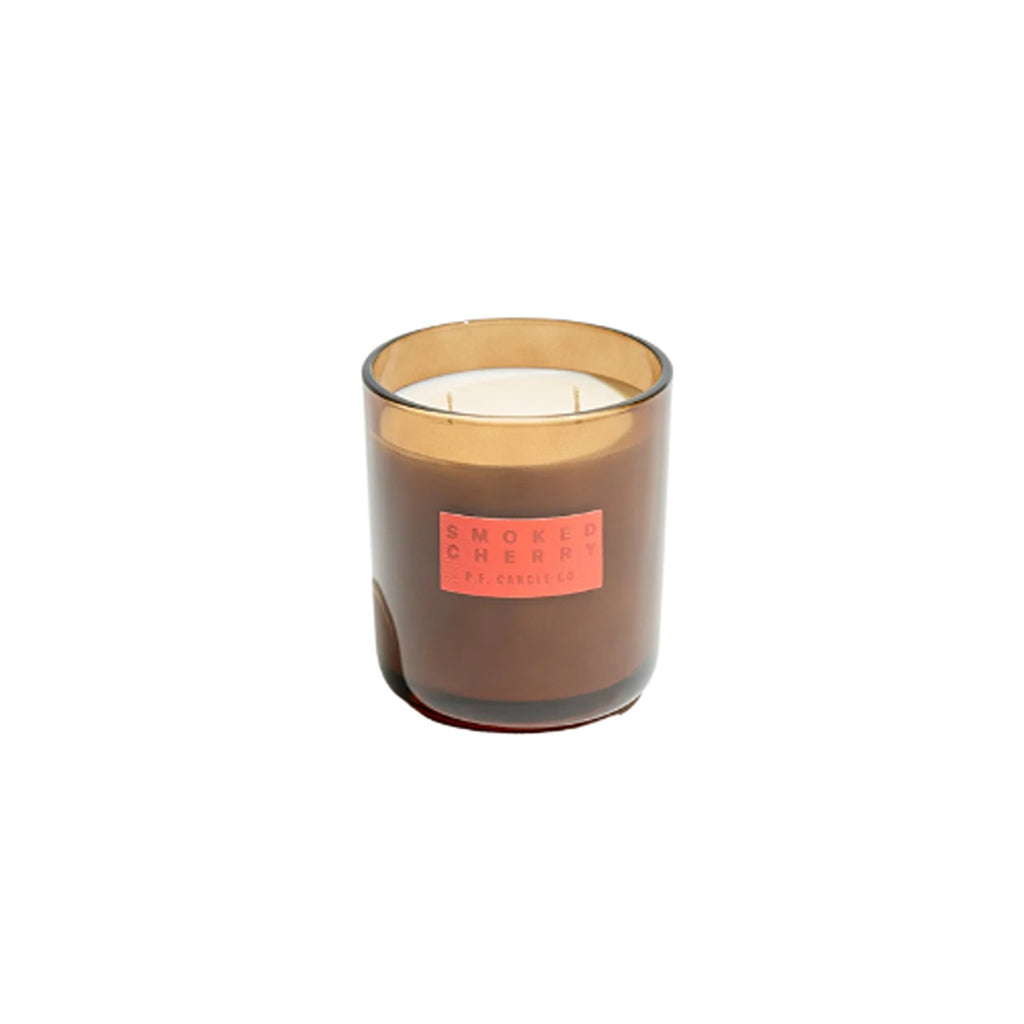 A HI-FI candle with a smoked cherry fragrance, offering a warm, rich scent that blends sweet cherry notes with a hint of smoky depth for a cozy, inviting atmosphere.