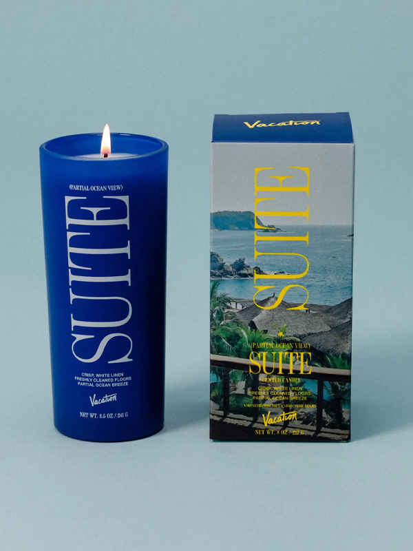 A scented candle from Vacation® featuring the fragrance of a relaxing ocean view suite, with a blend of fresh, coastal notes that evoke the feel of a serene beach getaway.