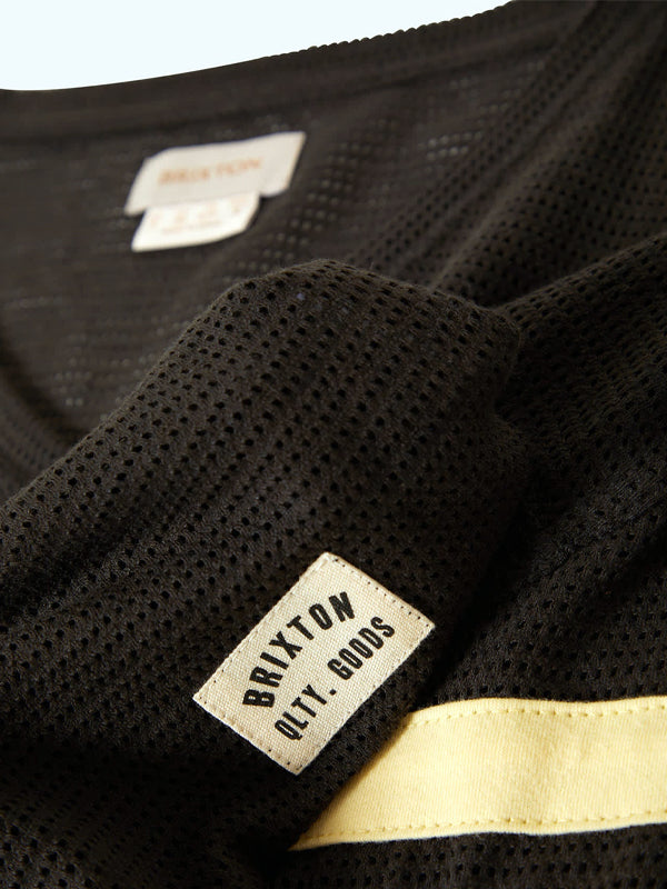 A washed black varsity football mesh tee, featuring a sporty, breathable design with a relaxed fit and a classic mesh fabric, perfect for casual or athletic wear."